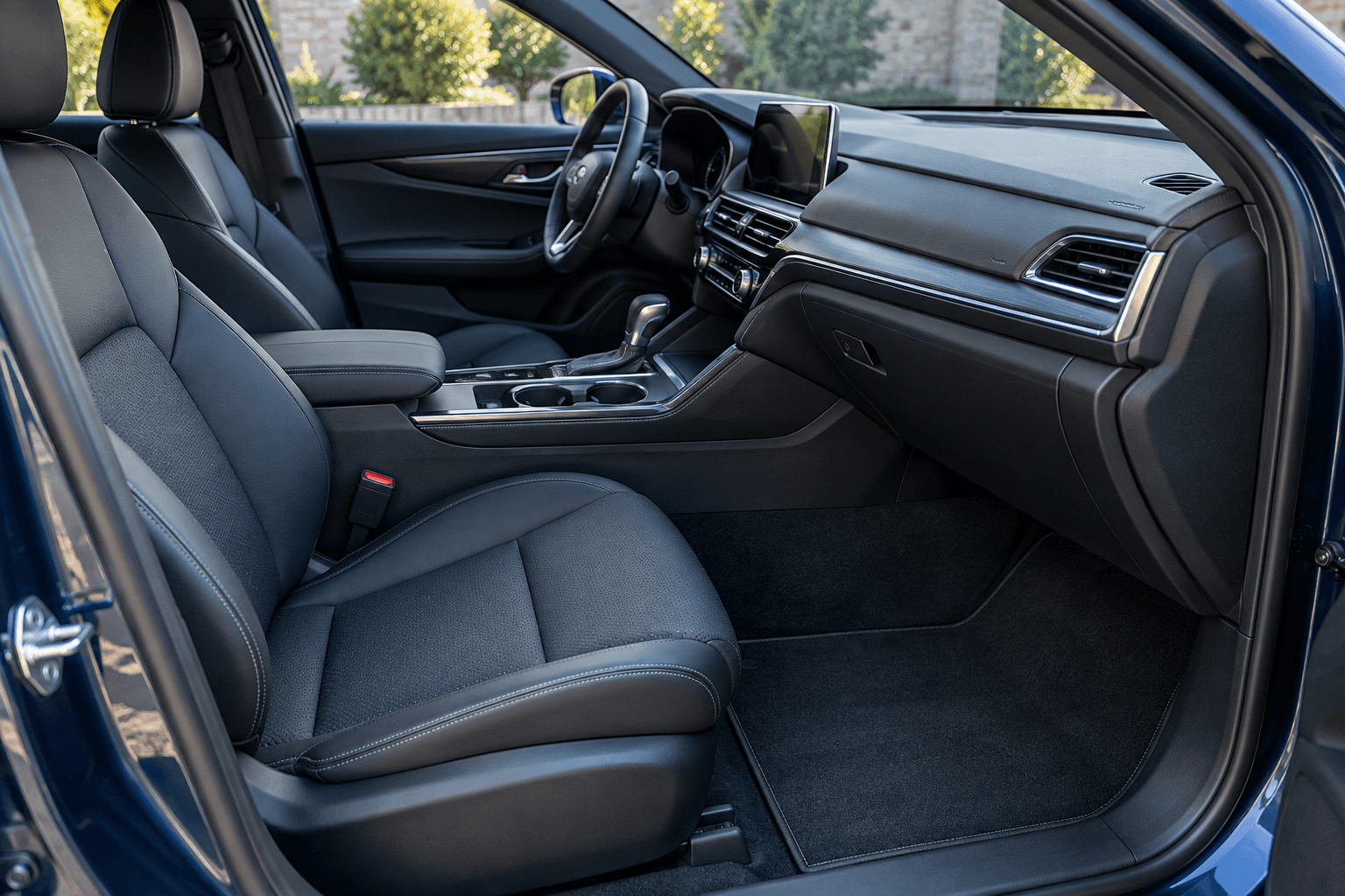 Illustration of a clean modern car cabin with seats, dashboard and floor mats.